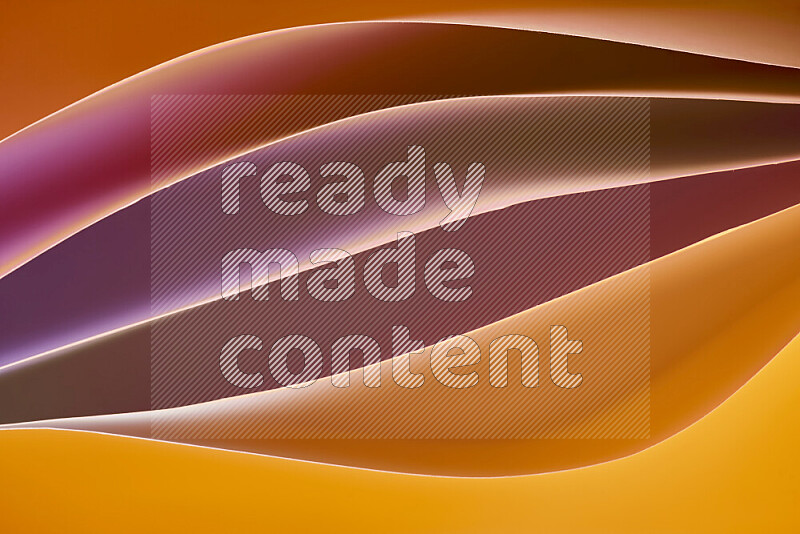 This image showcases an abstract paper art composition with paper curves in different warm gradients created by colored light