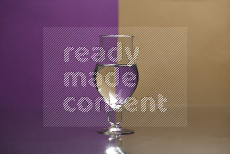 The image features a clear glassware filled with water, set against purple and beige background