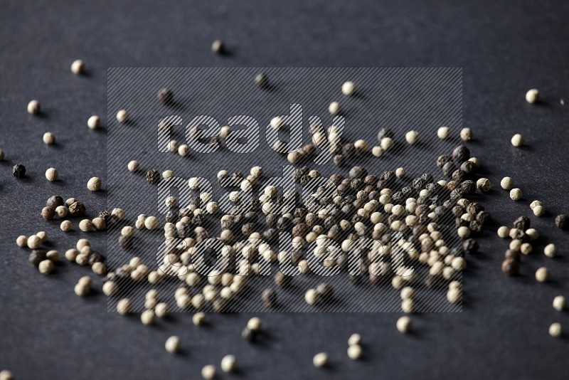 Mixed black and white pepper beads on a black flooring