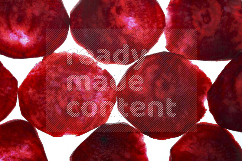 Beet slices on illuminated white background