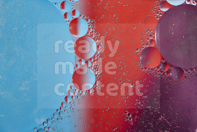 Close-ups of abstract oil bubbles on water surface in shades of blue, red and purple