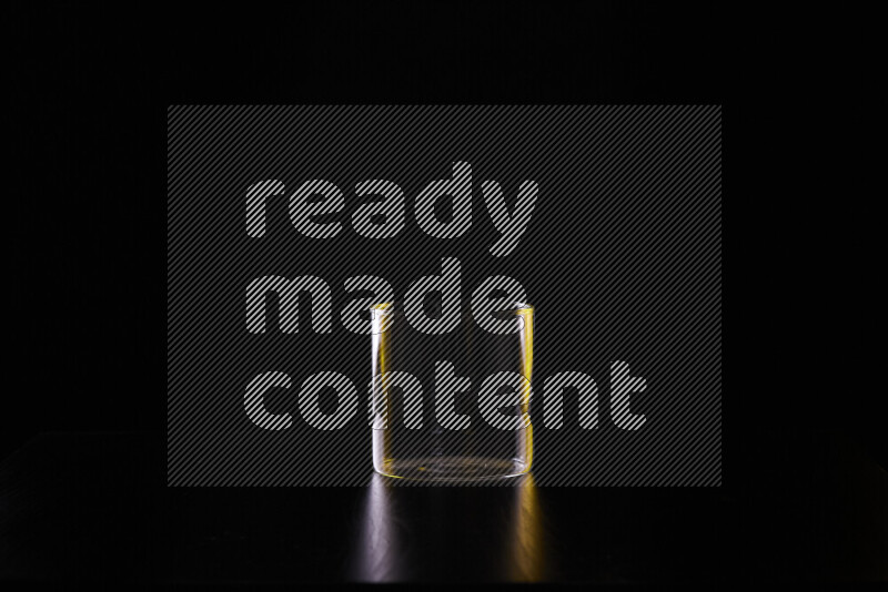 Glassware with rim light in yellow and white against black background