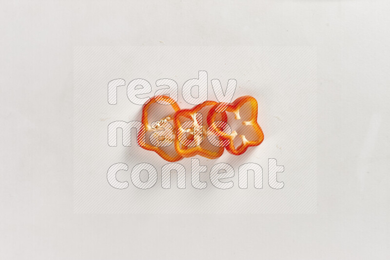 Red bell pepper slices on white background