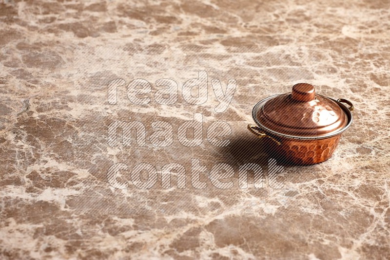 Small Copper Pot on Beige Marble Flooring, 45 degrees