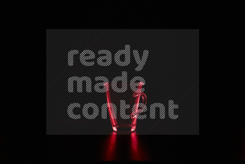 Glassware with rim light in red against black background