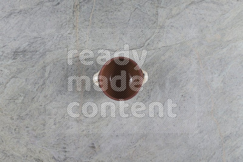 Top View Shot Of A Multicolored Pottery Pot On Grey Marble Flooring