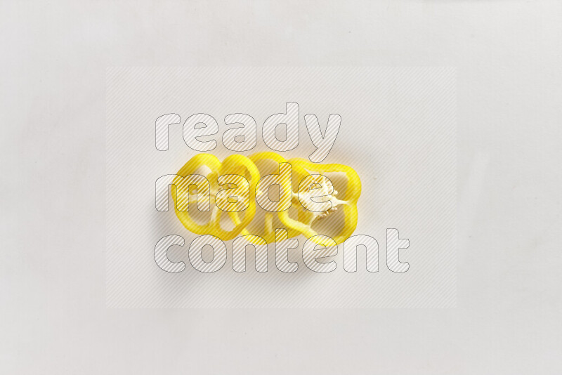 Yellow bell pepper slices on white background