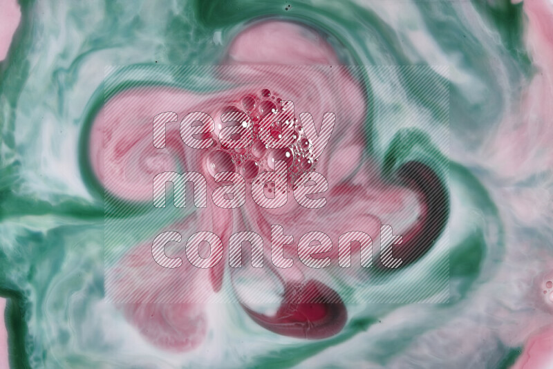 A close-up of abstract swirling patterns in red and green