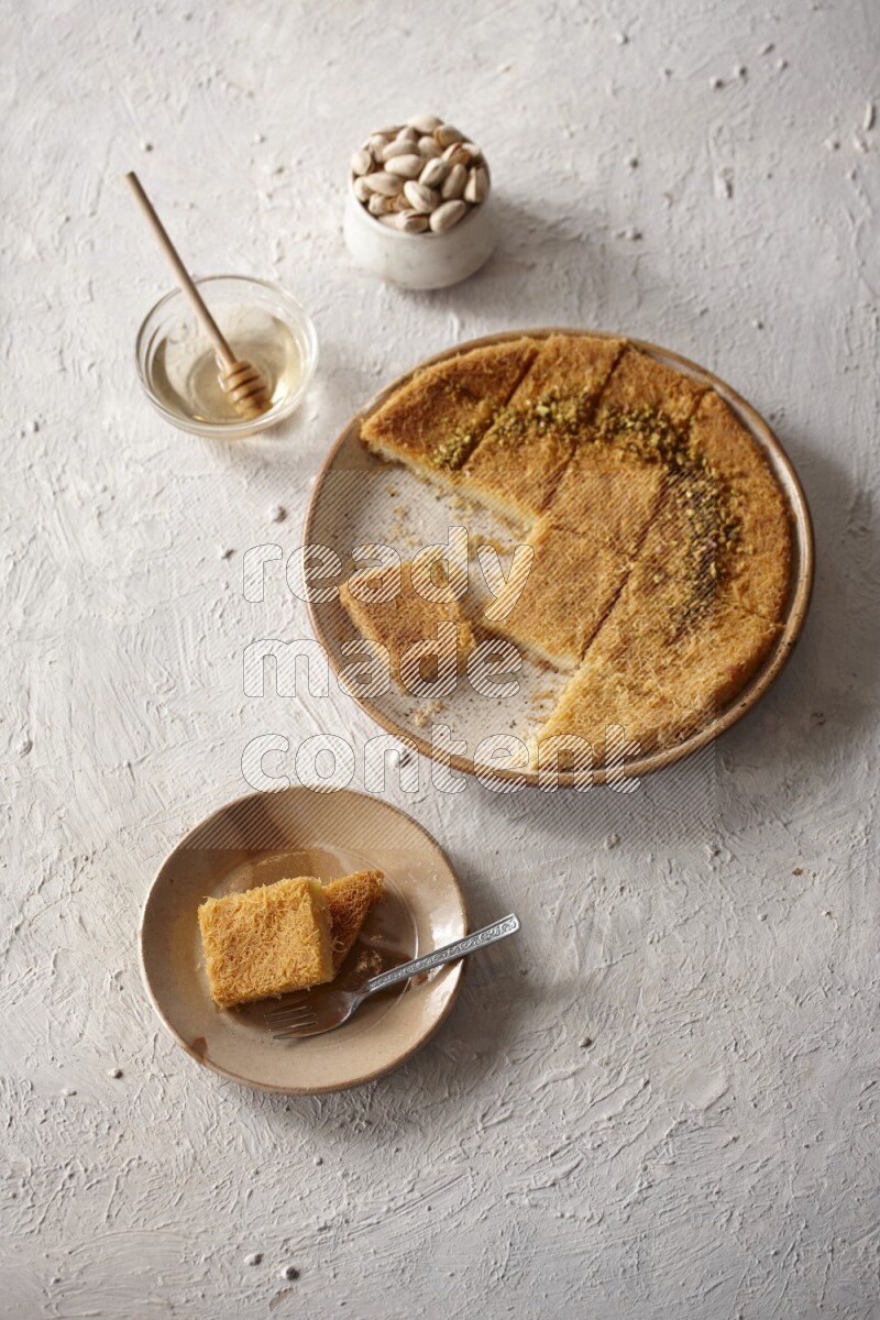 Konafa with nuts and honey in a light setup