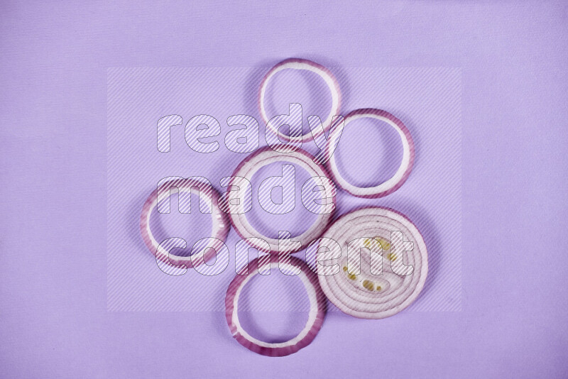 Red onions rings on purple background