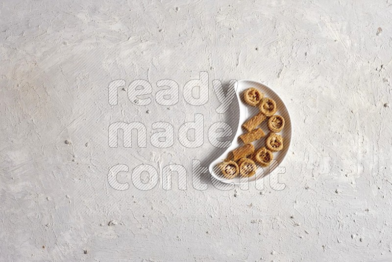 Oriental sweets in a pottery plate in a light setup