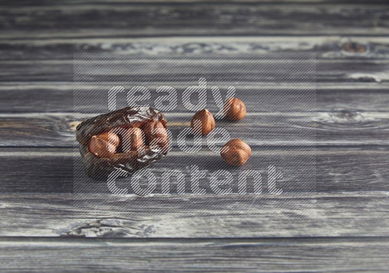 hazelnut stuffed madjoul date on a wooden grey background