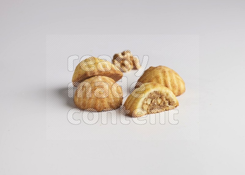 Four Pieces of Maamoul filled with walnut paste  one of them is cut direct on white background
