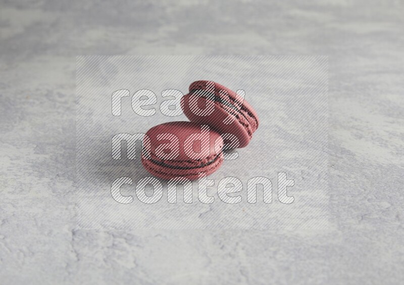 45º Shot of two Red Cherry macarons  on white  marble background