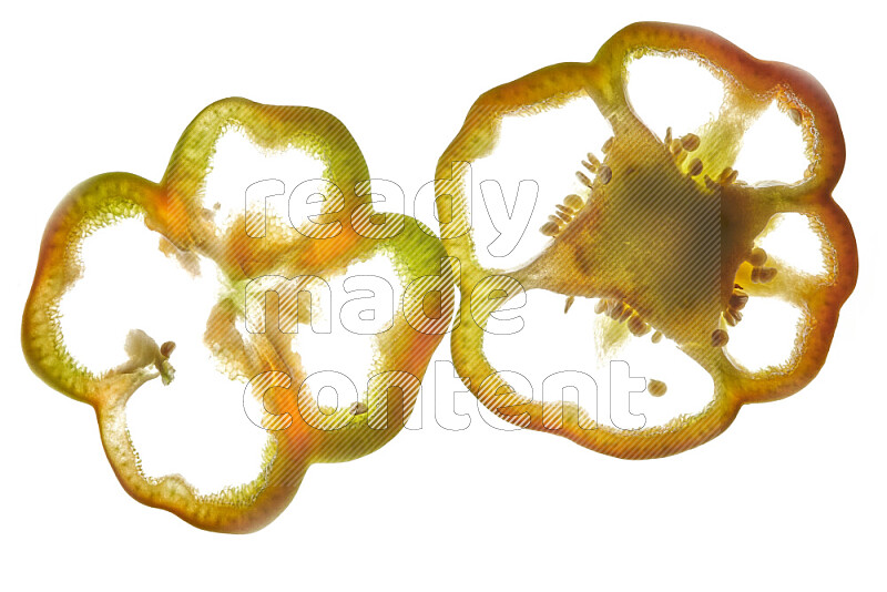 Colored bell pepper slices on illuminated white background