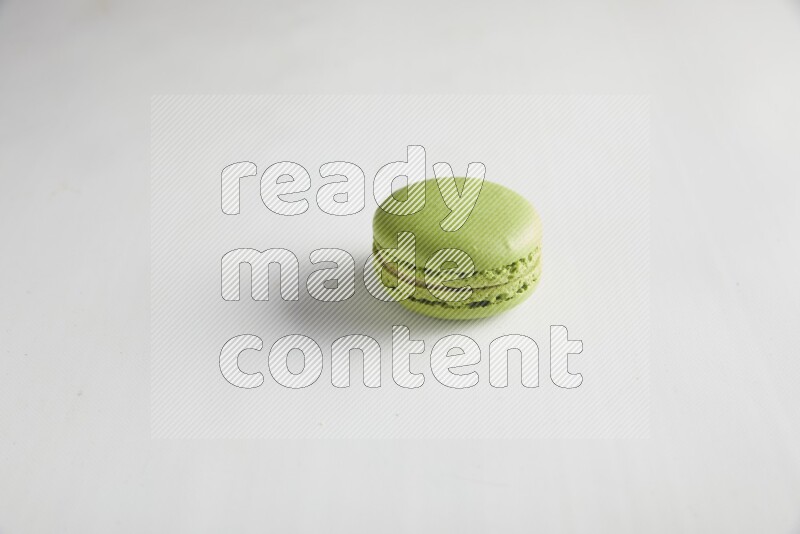 45º Shot of Green Pistachio macaron on white background