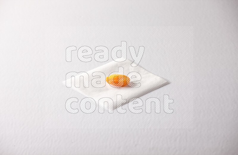 A dried apricot on a piece of paper on a white background in different angles