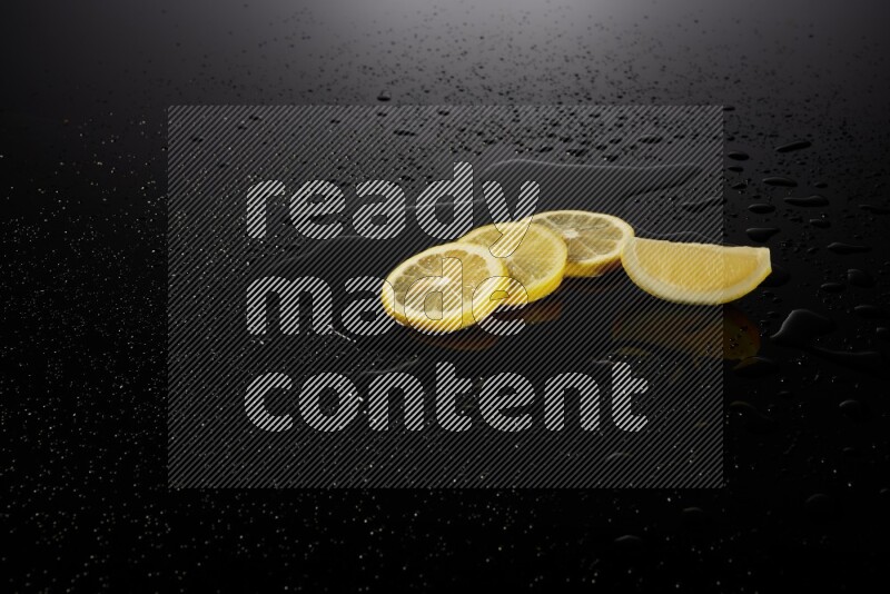 Lemon slices with water drops, and droplets on black background