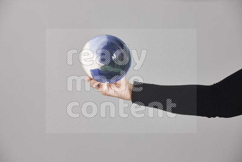A woman in black abaya holding different pottery essentials in different positions