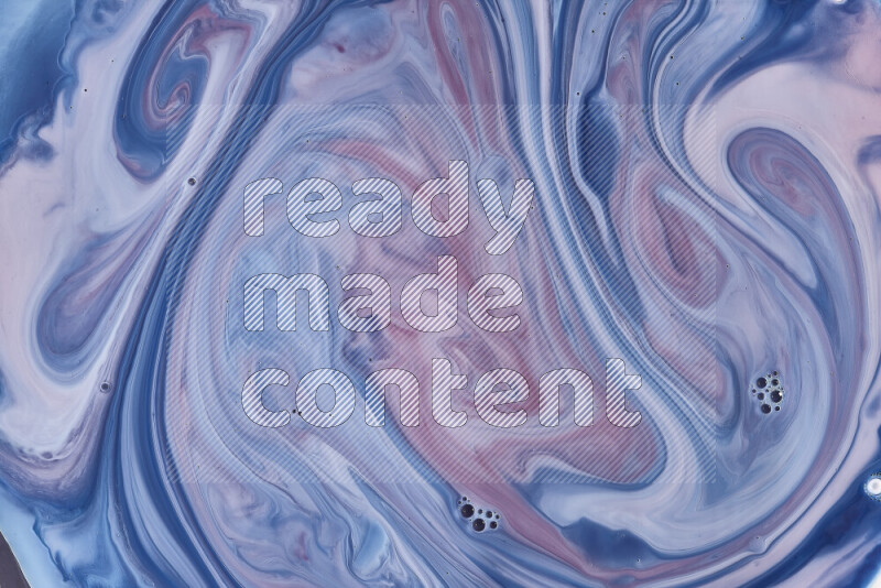 A close-up of abstract swirling patterns in blue, red and white