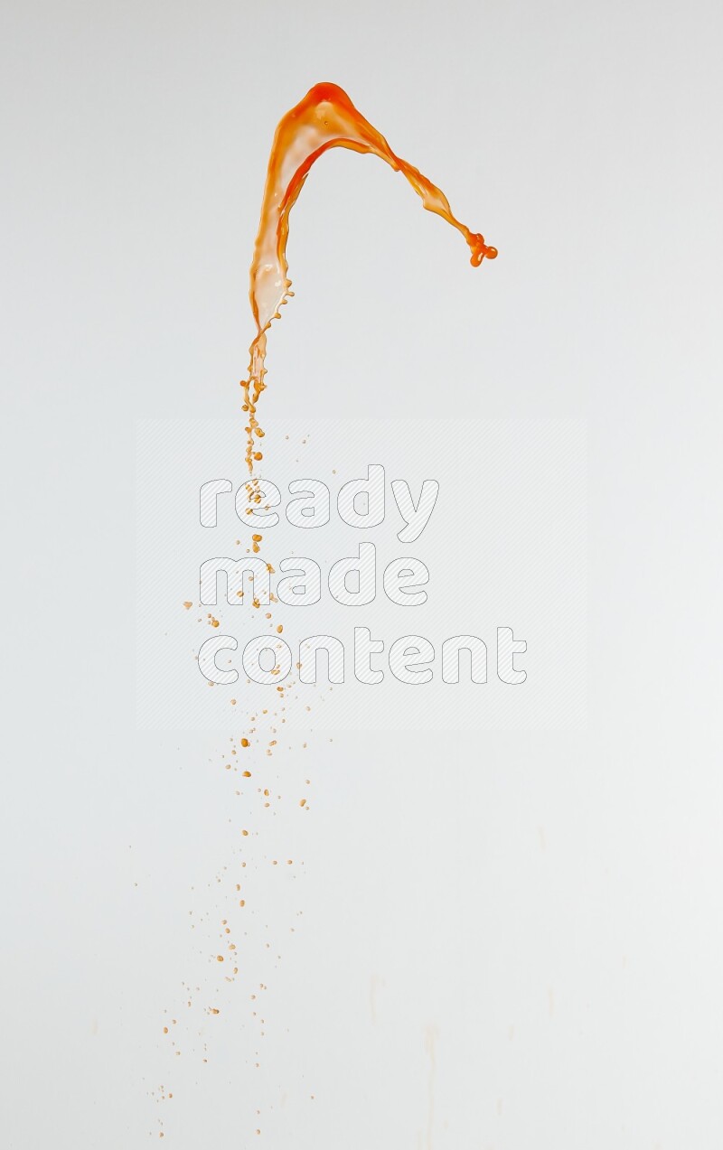 Orange liquid splash and drops on white background