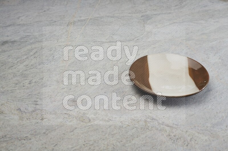 Multicolored Pottery Plate On Grey Marble Flooring