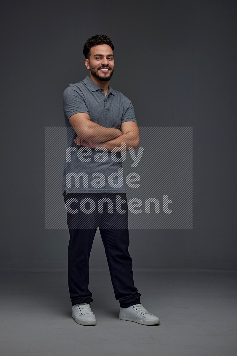 A man wearing casual making multi stand poses  eye level on a gray background