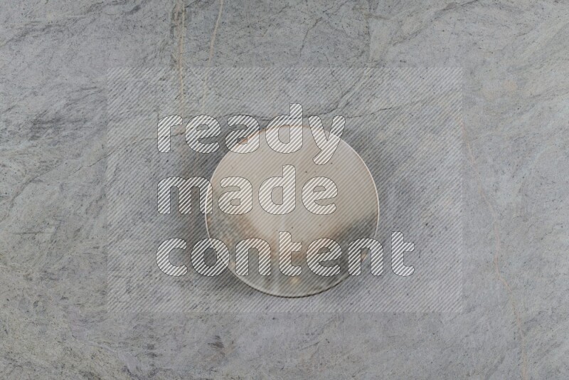 A multicolored pottery plate on grey marble background