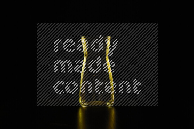 Glassware with rim light in yellow against black background