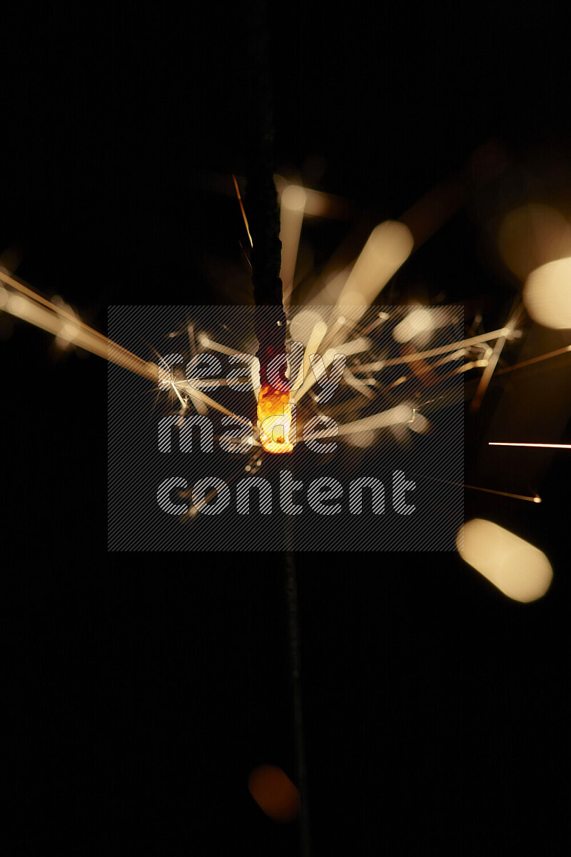 A close-up image of sparkler candle isolated on black background