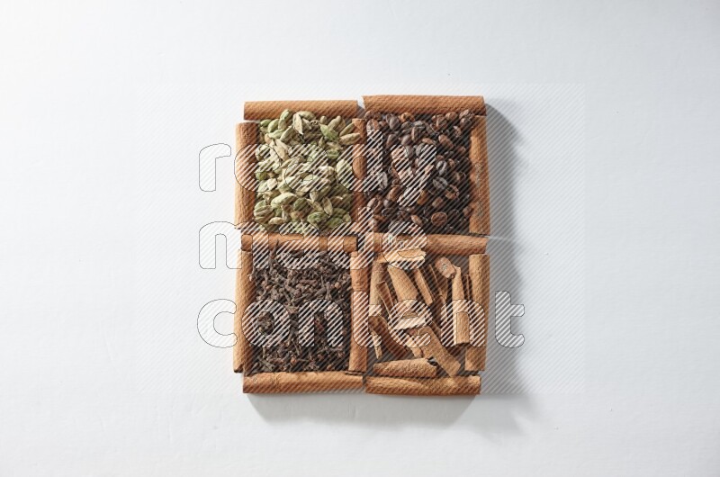 4 squares of cinnamon sticks full of coffee beans, cinnamon, cloves and cardamom on white flooring