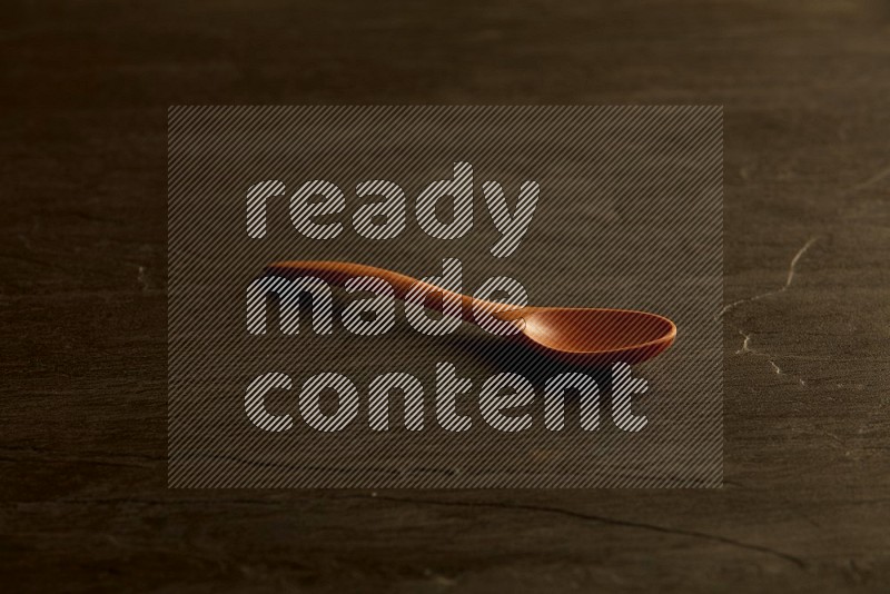 wooden spoon on black slate background