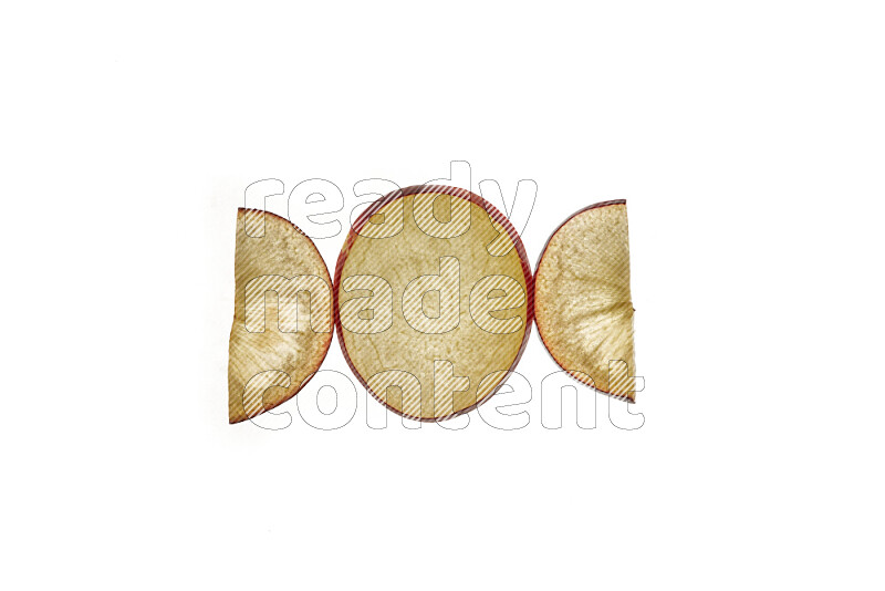 Plum slices on illuminated white background