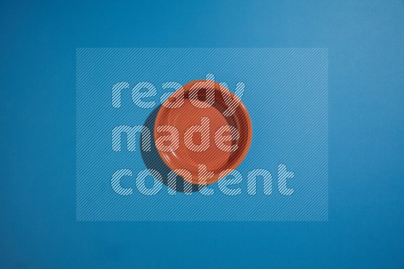 brown bowl on blue background