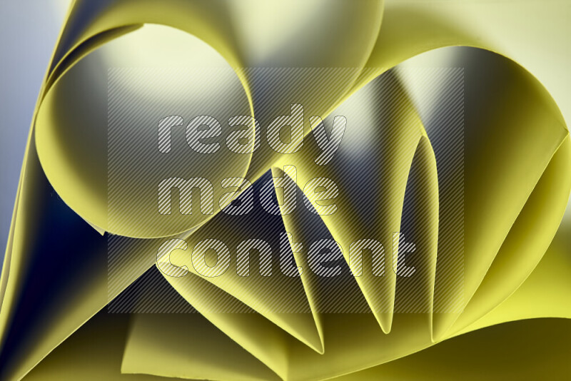 An artistic display of paper folds creating a harmonious blend of geometric shapes, highlighted by soft lighting in green tones