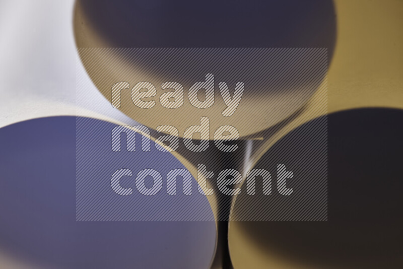 The image shows an abstract paper art with circular shapes in varying shades of grey and warm tones