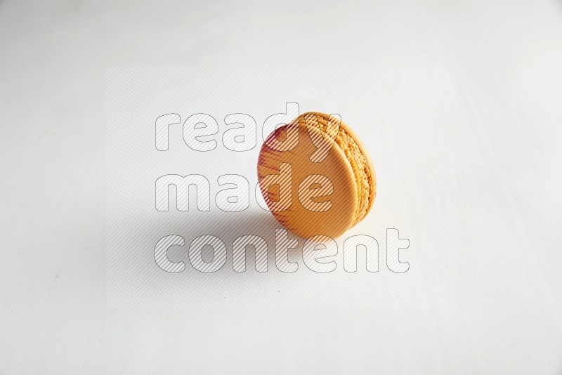 45º Shot of Orange Exotic macaron on white background