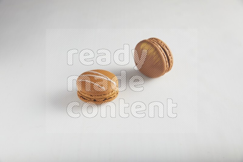 45º Shot of of two assorted Brown Irish Cream, and Brown Coffee macarons  on white background