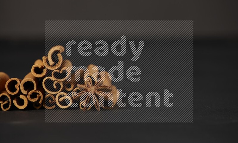 Cinnamon sticks and star anise on a black background