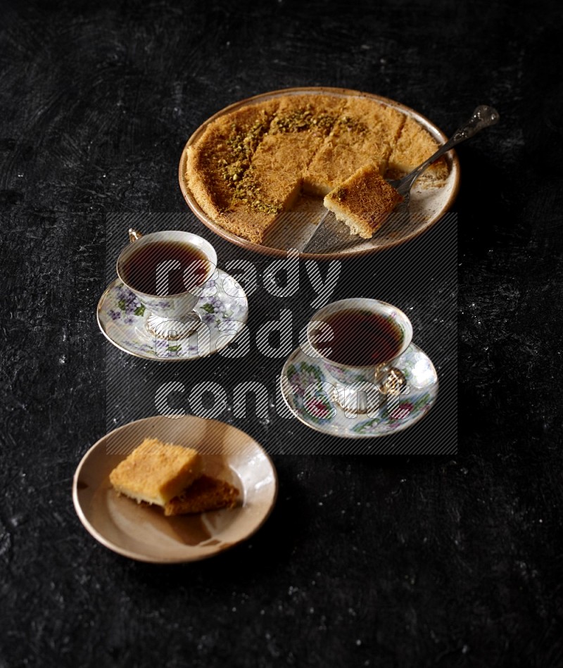 konafa with tea in a dark setup