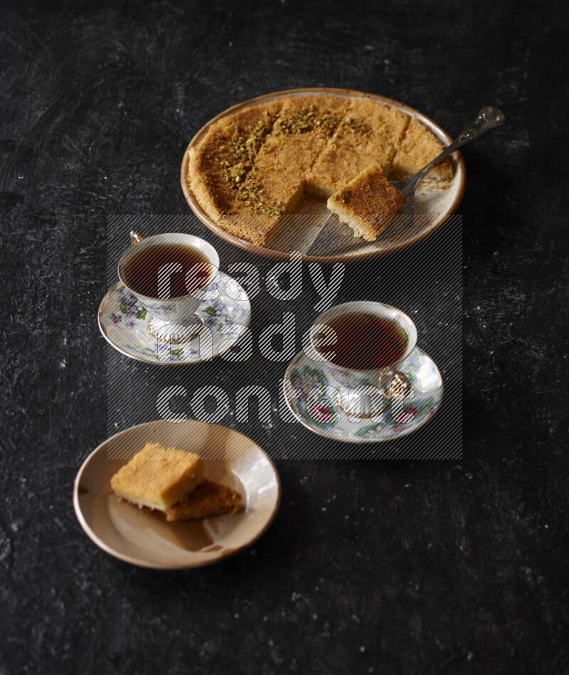 konafa with tea in a dark setup