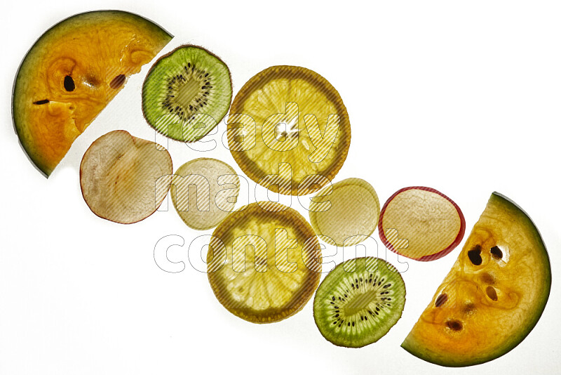 Mixed fruits slices on illuminated white background