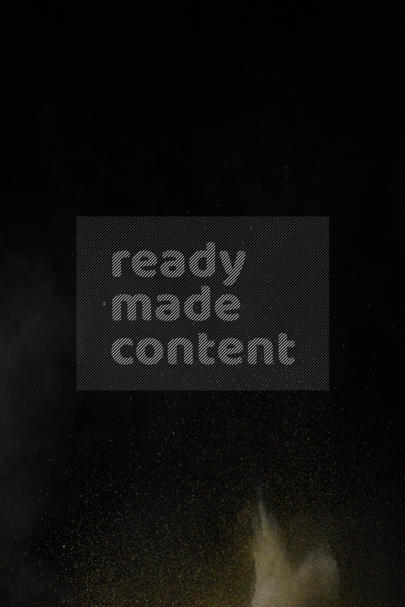 A side view of brown powder explosion on black background