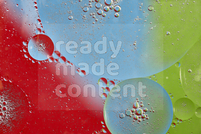 Close-ups of abstract oil bubbles on water surface in shades of red, green and blue