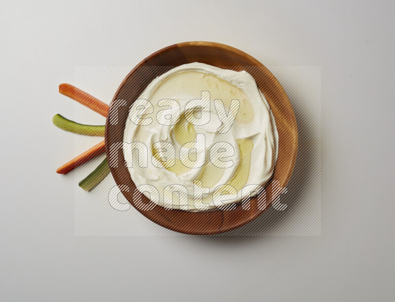 Lebnah garnished with olive oil in a wooden plate on a white background