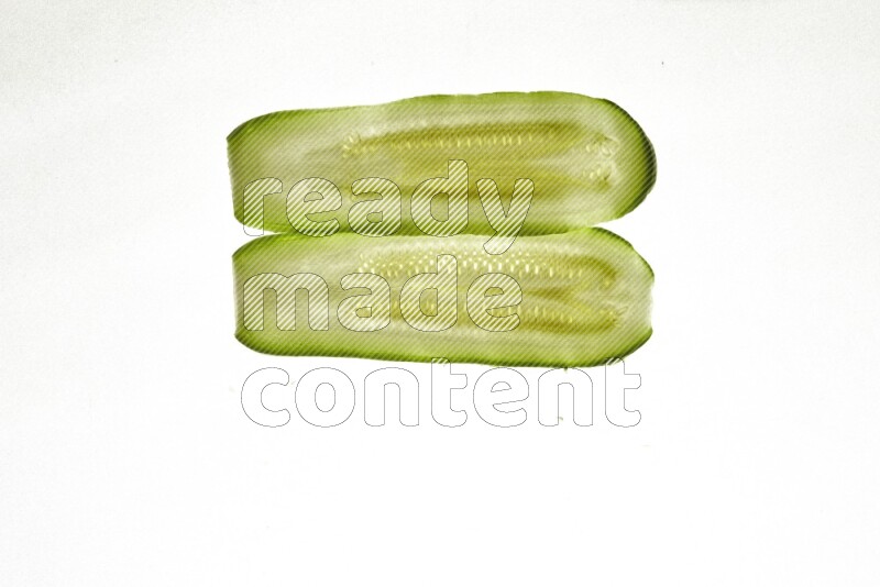 Zucchini slices on illuminated white background