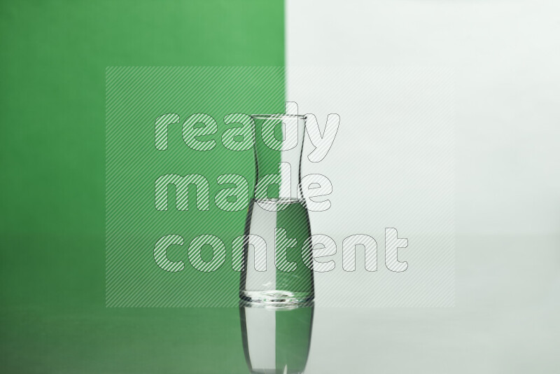 The image features a clear glassware filled with water, set against white and green background