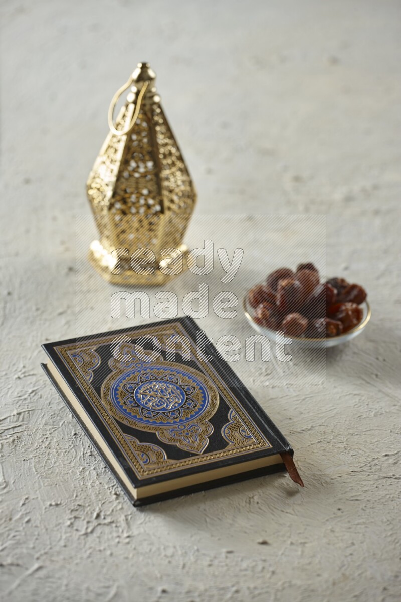 A golden lantern with different drinks, dates, nuts, prayer beads and quran on textured white background