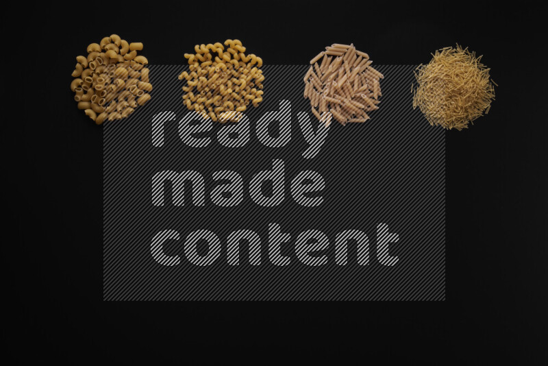 Different pasta types in 4 bunches on black background