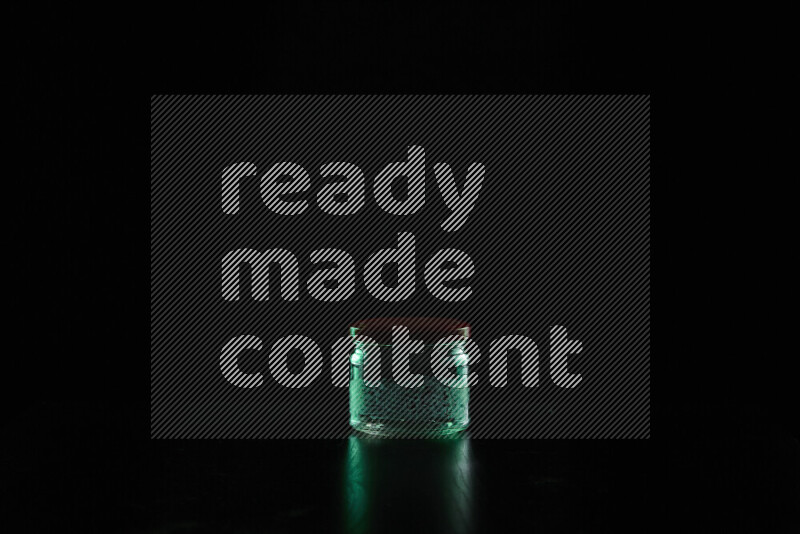 Glassware with rim light in green against black background